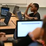 Students in our micro school working on laptops